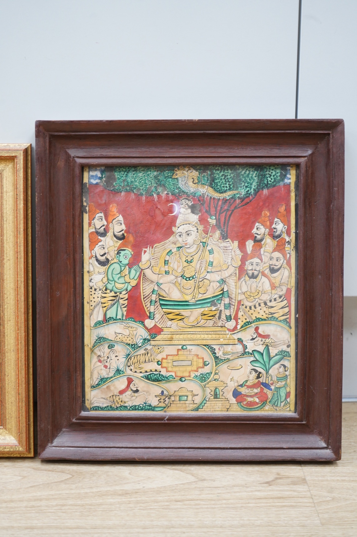 Rajasthan, 19th century, Stylised oil on wood panel, together with a similar example of a deity, watercolour on paper, largest 27 x 24cm